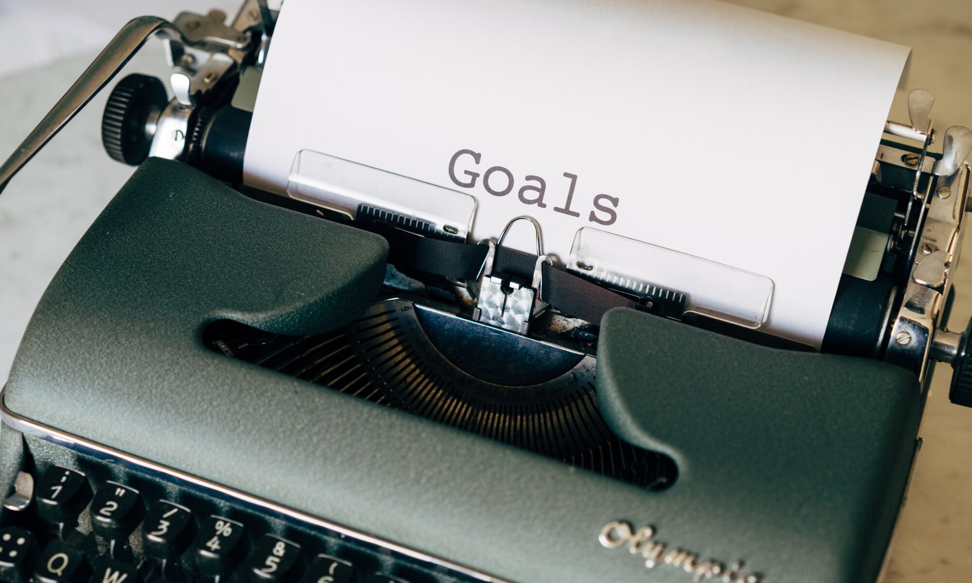 A typewriter with a page showing goals on it